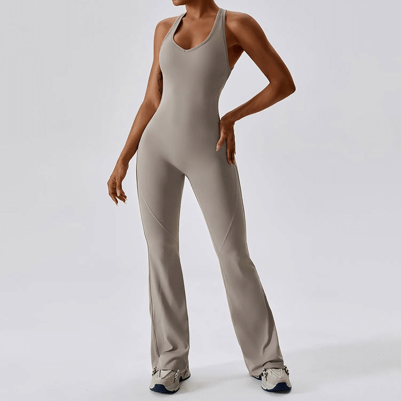 Woman wearing SF1597 fitness open back compressed jumpsuit for yoga and gym, showcasing flexible and breathable design.